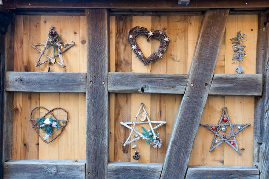 Wooden timber wall decorated with Christmas star and heart ornaments