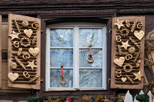 Christmas window decorated with carved wooden ornaments in France