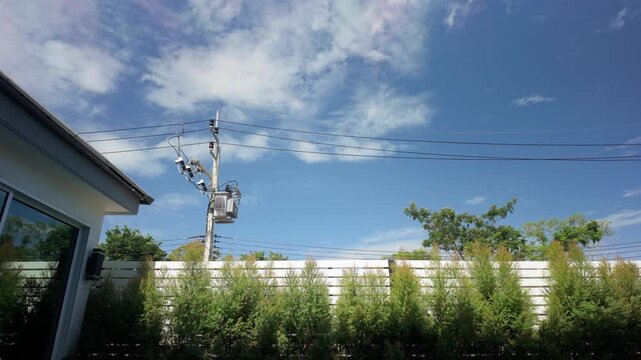 Trees Swaying in Breeze Outside House on Sunny Day