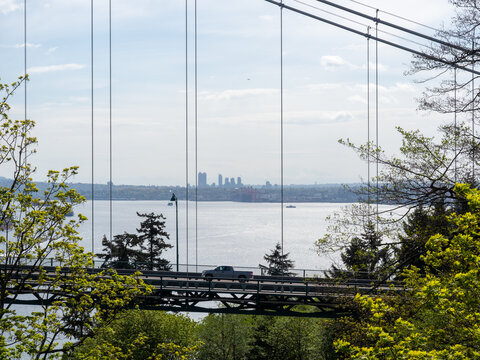 Car crossing Lions Gate bridge, view from Prospect Point Lookout in Stanley Park - Vancouver BC, Canada