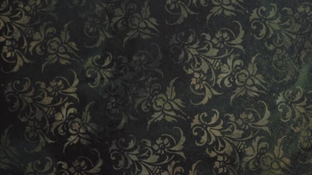 Close Up Shot of Vintage Gold Floral Damask Pattern on Dark Textured Background