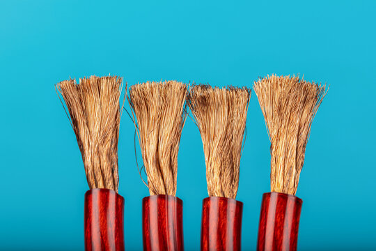 Copper wire insulated with red rubber on a blue background. Close up