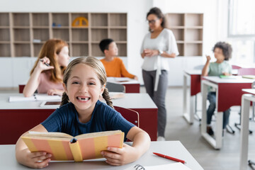 Fototapeta premium Engaging classroom moments with diverse young learners and their teacher