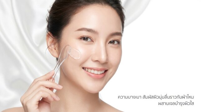 Young woman using a facial roller. Beauty model applying skincare treatment on her face.