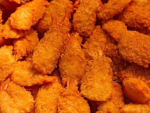 Full frame top down view of crispy golden breaded butterfly shrimp.