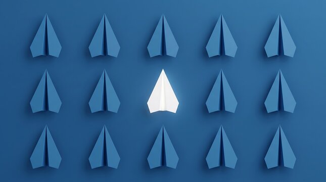Unique white paper plane standing out among uniform blue aircrafts on solid colored background