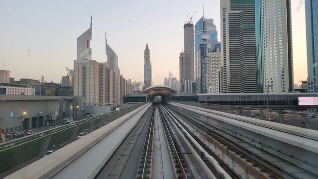 Modern skyscrapers and transportation in Dubai during dusk hours