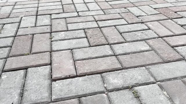 Reddish terracotta interlocking concrete paving blocks texture background