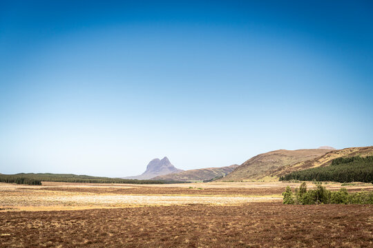 A sunny, summer HDR landscape image of Suilven from Ledmore Junction in Assynt, Sutherland, Scotland. 
