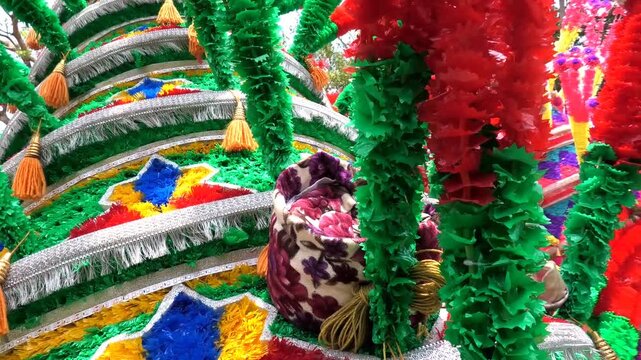 Closeup of colorful spinning structures traditionally used in the 'Kavadi' procession of temple festivals in South India
