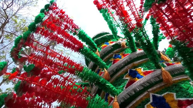 Closeup of colorful spinning structures traditionally used in the 'Kavadi' procession of temple festivals in South India