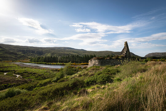 A bright summer, wide angled HDR landscape image of the remains of the Iron Age Broch, Dun Dornaigil in Strath more, Sutherland, Scotland