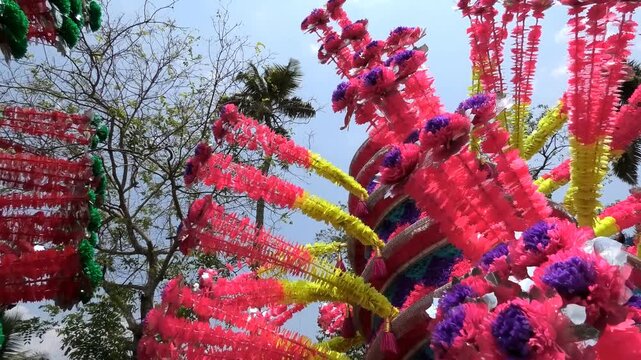 Closeup of colorful spinning structures traditionally used in the 'Kavadi' procession of temple festivals in South India