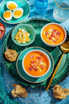 Traditional Spanish gazpacho soup (Salmorejo) served with ham and boiled eggs