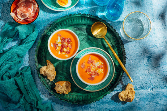 Traditional Spanish gazpacho soup (Salmorejo) served with ham and boiled eggs