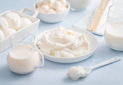 Delicious dairy products arranged on a light blue background for culinary inspiration