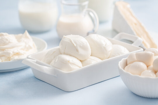 Delicious dairy products arranged on a light blue background for culinary inspiration