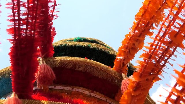 Closeup of colorful spinning structures traditionally used in the 'Kavadi' procession of temple festivals in South India
