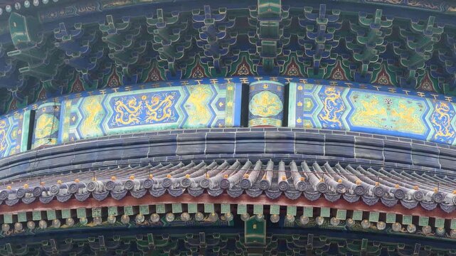 Decorative traditional Chinese wooden architecture with golden dragon pattern. Ancient temple detail with intricate ornate carvings. Cultural heritage and history of Asia landmark.