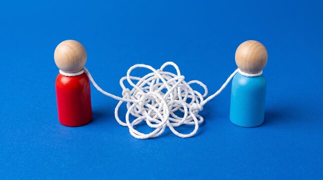 Complex communication concept with wooden figures and tangled string, messy connection between people, psychological therapy and relationship problem