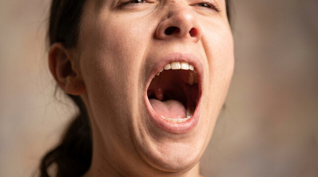 A close-up view of a woman with her mouth wide open, showing her throat and tonsils during ad social media download thambnail poster web template event festival 2026 2027 2028