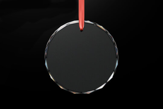 Round Crystal Glass Ornament Hanging on Red Ribbon Against Black Background. 3d rendering