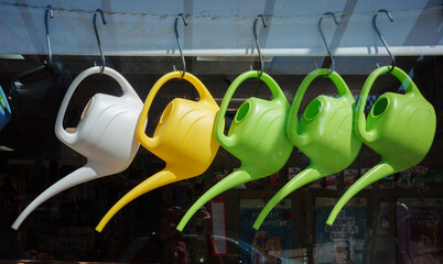 watering cans on display in the sun © Ian