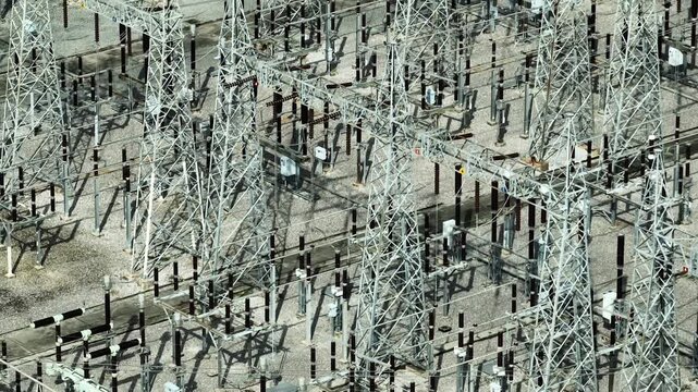 Drone photography of high voltage switchgear infrastructure showing organized electrical networks, advanced control systems, and critical energy facilities designed for continuous power reliability.
