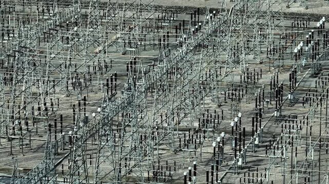 An electrical transmission substation with intricate equipment layouts, representing smart grid technology, renewable energy integration, and modern power management infrastructure. 4k.
