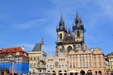 Fototapeta premium Prague historic old town square with gothic church and pastel facades for travel banner and city background. Church of the Mother of God before Tyn