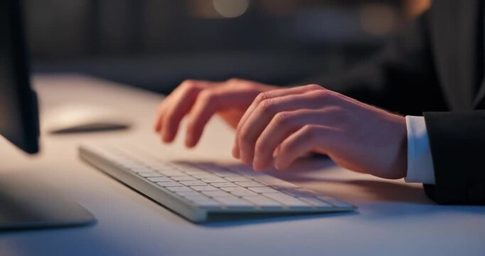 Close up of hands typing on computer keyboard
