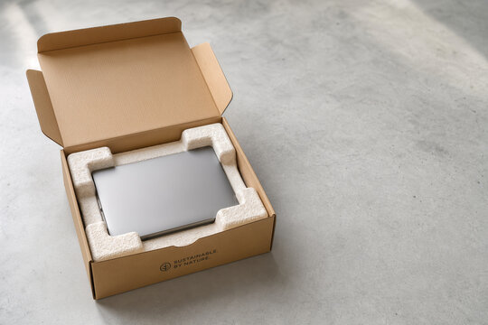 Sustainable mycelium packaging for electronic device in kraft cardboard box eco friendly biodegradable shipping buffer for logistics and circular economy innovation photography