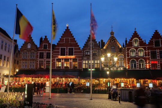 Evening cafe terraces in historic gabled town square Belgium