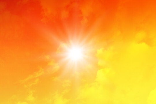Hot sun in the orange sky, sunny weather and extreme temperature background