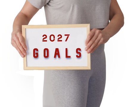 2027 goals. Faceless image of a woman in sportswear showing a whiteboard