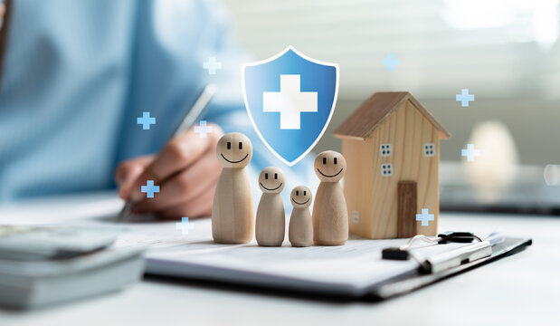 Family health insurance concept with wooden figures, house model and medical shield icon on documents, symbolizing financial protection, healthcare coverage, home security and future planning.
