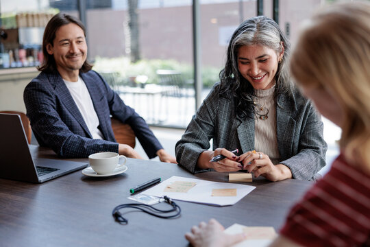 Business meeting with diverse team brainstorming ideas.