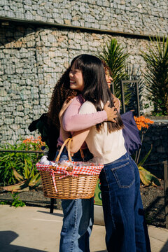 Two women hug at a meeting