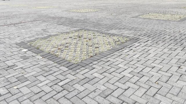 Wide angle interlocking concrete paving block street with decorative patterns