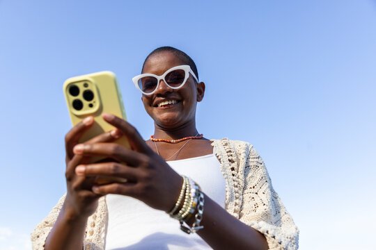 Black woman  Cell phone outdoors close up 