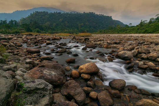 Scenic beauty of Jaldhaka River and stones at river bed, flowing through India, Bhutan, and Bangladesh. Originating from Kupup Lake in East Sikkim. At Jhalong-Dooars, north bengal- West Bengal, India.