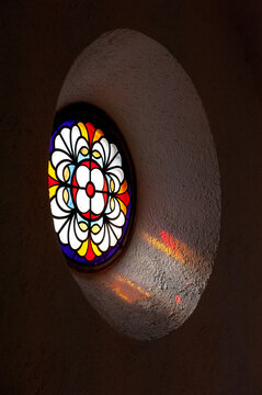Colorful historic stained glass illuminates interior