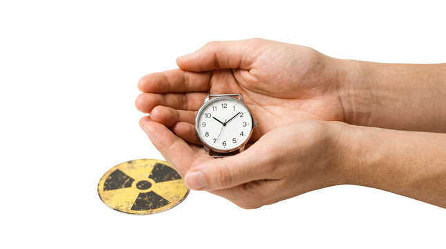 Nuclear doomsday clock held in cupped hands, radiation hazard symbol and silver wristwatch, concept of atomic time and global catastrophe risk isolated PNG with Transparent Background