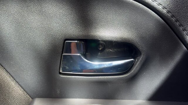 male driver pressing button locking doors in car