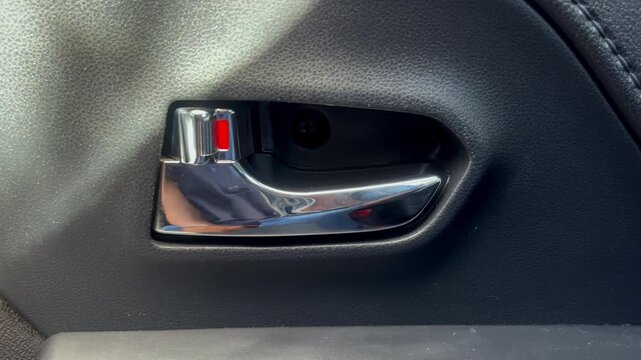 male driver pressing button locking doors in car