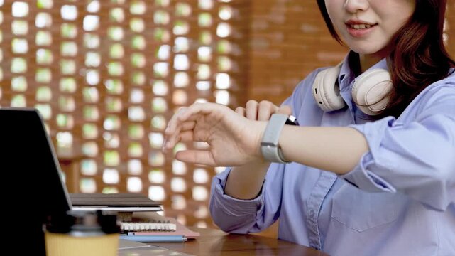 Young Asian Businesswoman Working Remotely with Laptop and Smartphone in Traditional Wooden Cafe, Digital Nomad Lifestyle
