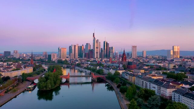 Aerial skyline view of Frankfurt am Main featuring the modern financial district and iconic skyscrapers at sunset in Germany.