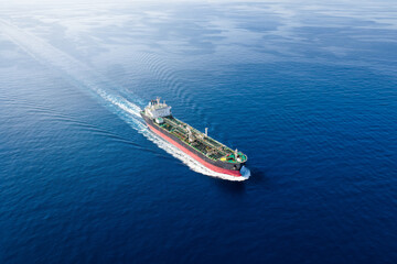 High aerial view of a crude oil or chemical goods tanker sailing with speed over calm ocean as a concept for transport and industry © moofushi