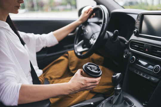 Driving with takeaway coffee
