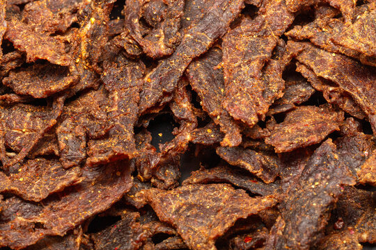 Smoked beef jerky slices covered in spicy seasoning